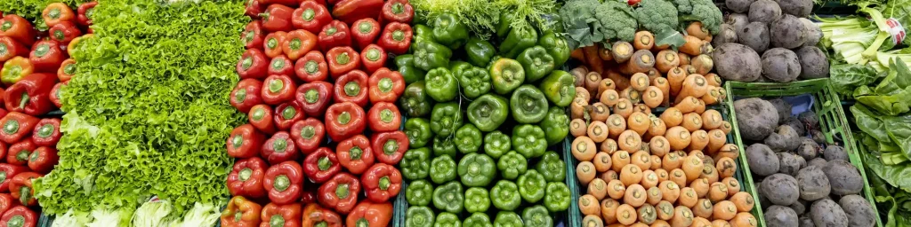 Delicious fresh vegetables and fruits at the refrigerated section of a supermarket